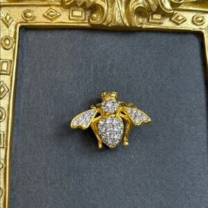 Joan Rivers gold-tone bee pin with clear pavé-set crystals and green eyes